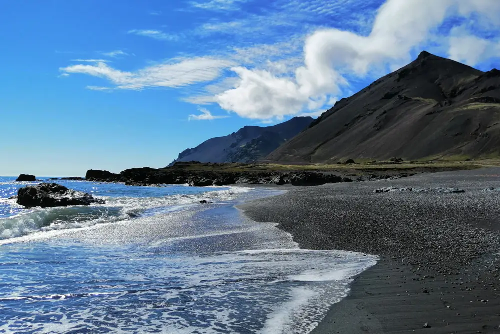 A black sand beach on a sunny day in Iceland