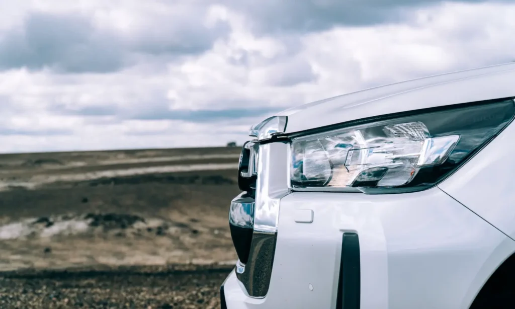 Bumper of a white camper on an Icelandic road beneath low clouds