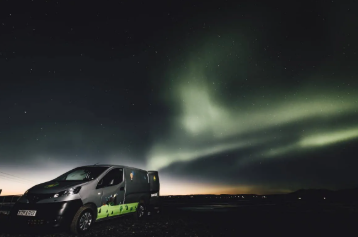 Campervan parked under the Northern Lights in Iceland