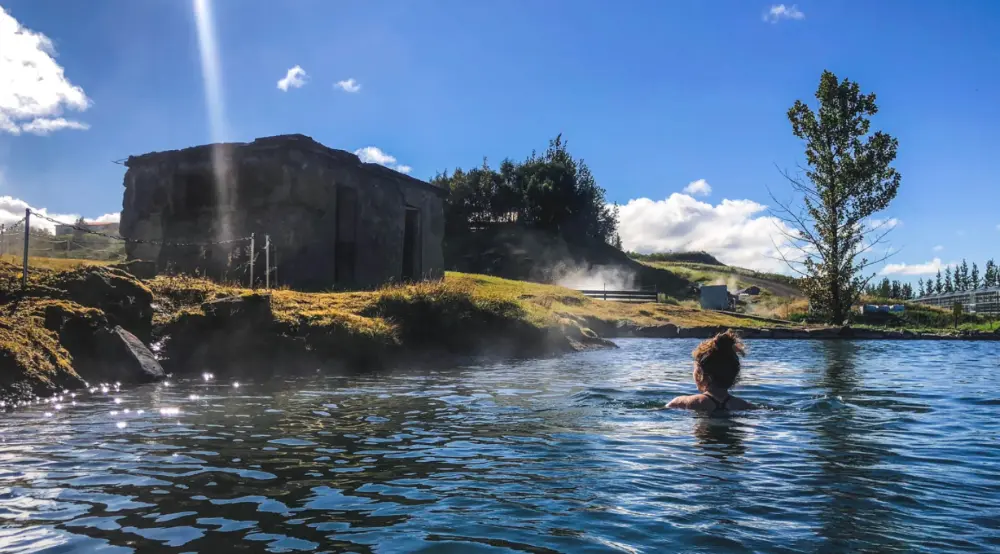 Woman swimming in Secret Lagoon, Iceland.