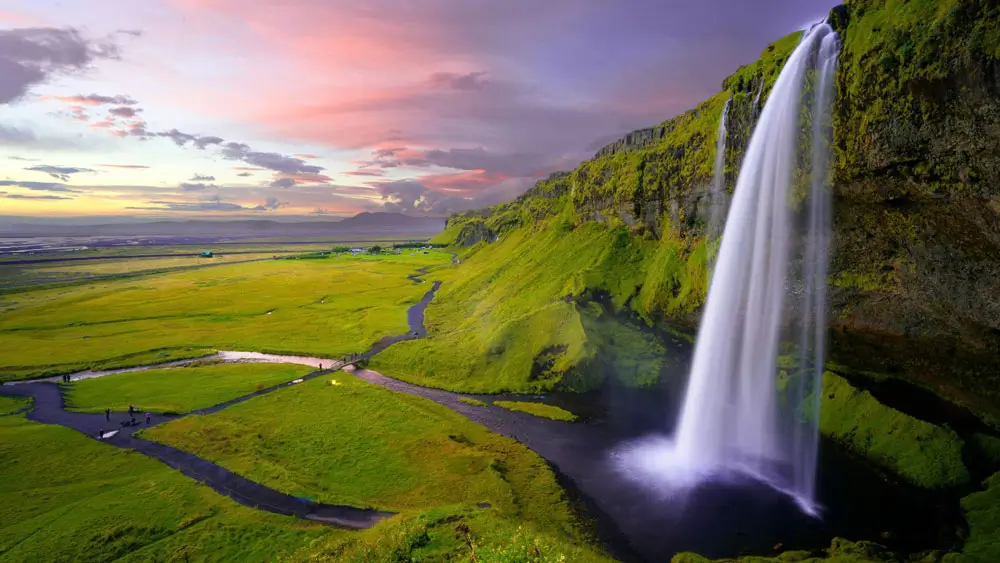 Seljalandsfoss waterfall in Iceland at sunset.
