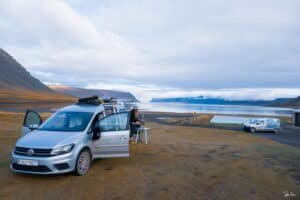 VW Caddy camper camped by a lake