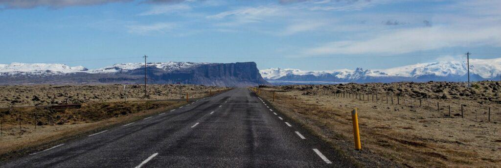 A road between fileds of mosscovered lava