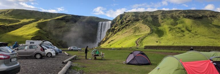 Campsite and parking lot next to a waterfall