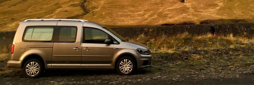 Camper van parked on a gravel road in iceland