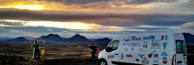 rent.is campervan parked next to people smiling in the icelandic nature