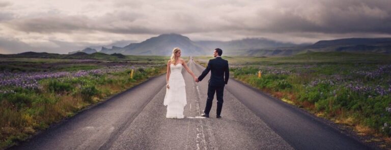 Bride and groom standing on a road in Iceland