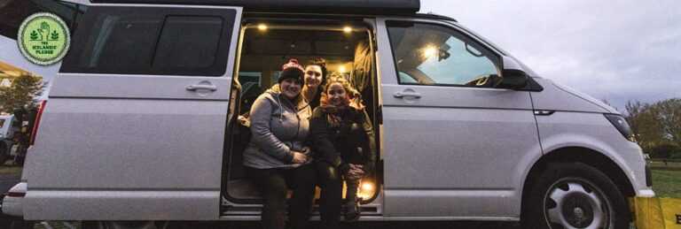Women inside a 4x4 rent.is camper van with rooftop tent