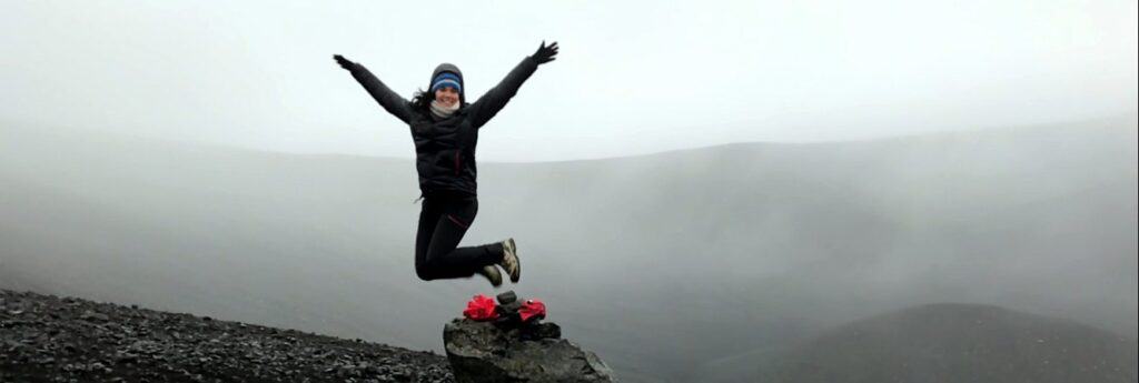 Woman jumping off a rock
