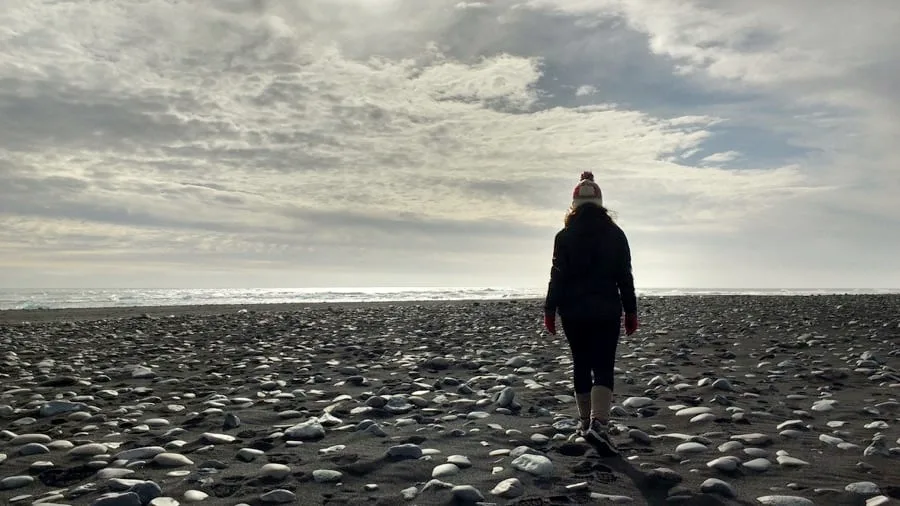 Walking on a black sand beach Walking on a black sand beach