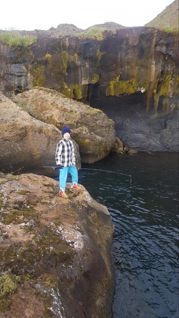 child holding a fishing pole