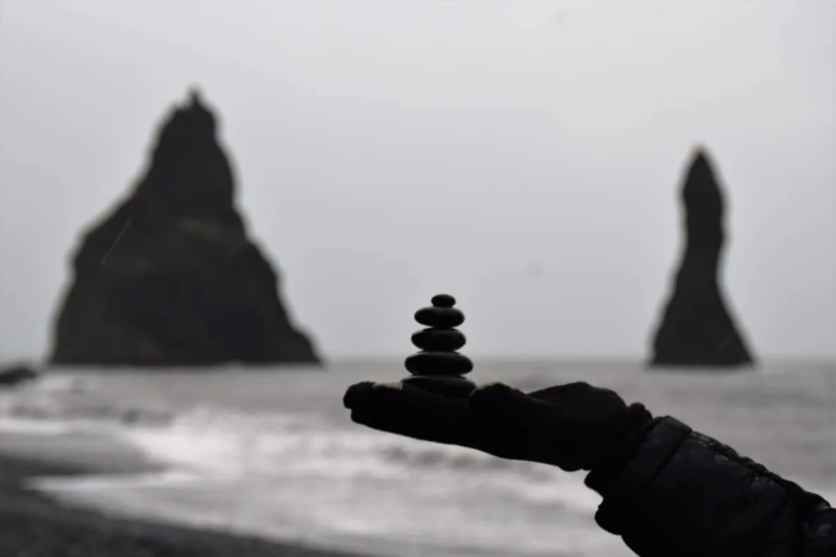 Playing with stones at Reynisfjara Playing with stones at Reynisfjara