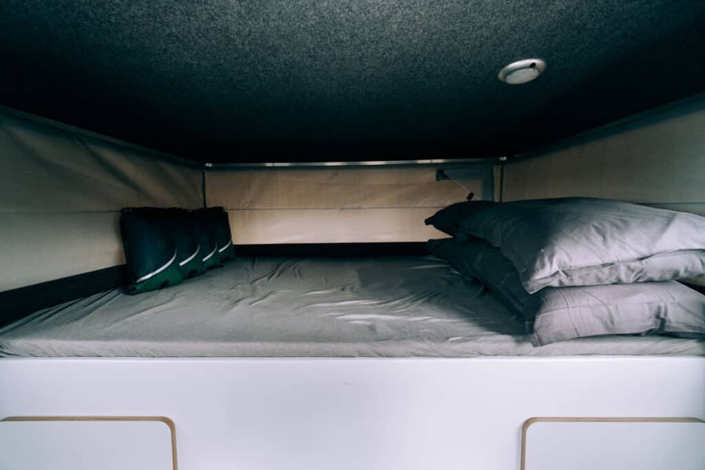 Toyota Hilux 4×4 Camper sleeping area, pillows, sleeping bags