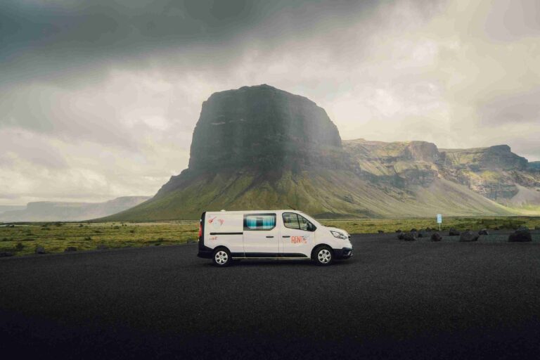 Trafic 3 parked infront of a mountain and fog