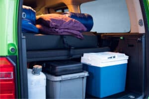 Rent VW Caddy Camper interior sleeping bags, pillows, trunk