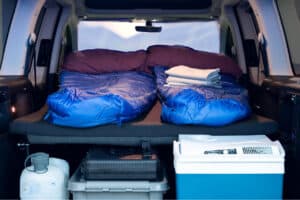Rent VW Caddy Camper interior cooler sleeping bags water tank griddle