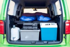 Rent VW Caddy Camper interior included water tank, griddle, cooler, storage