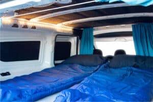 Rent renault kangoo camper interior sleeping bags curtains