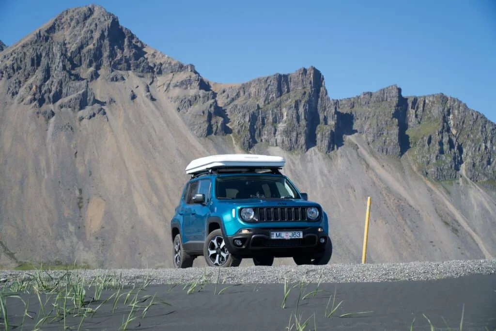 rent.is camper van jeep renagade with roof top tent on road in Iceland