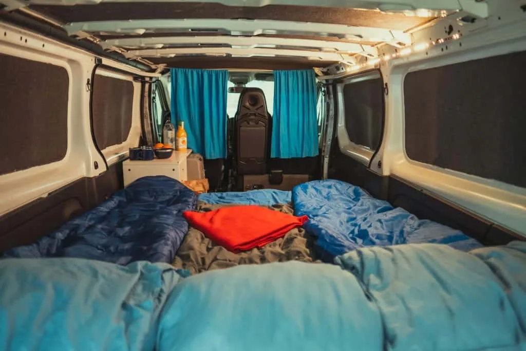 bed with sleeping bags interior of rent campervan renault trafic