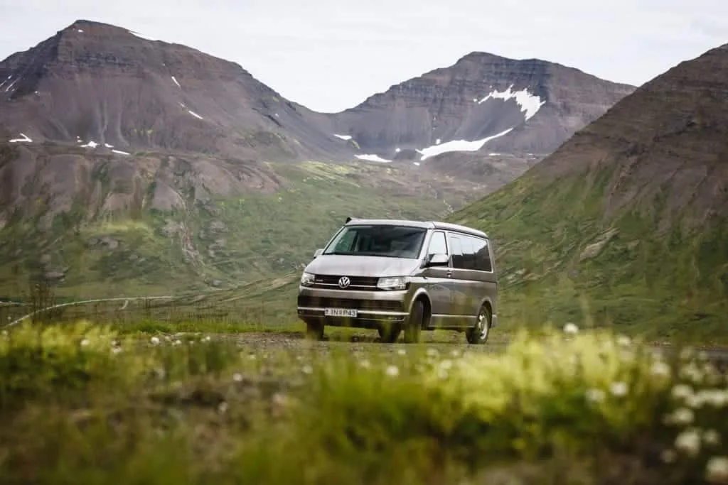 VW california camper van in icelandic nature with mountains