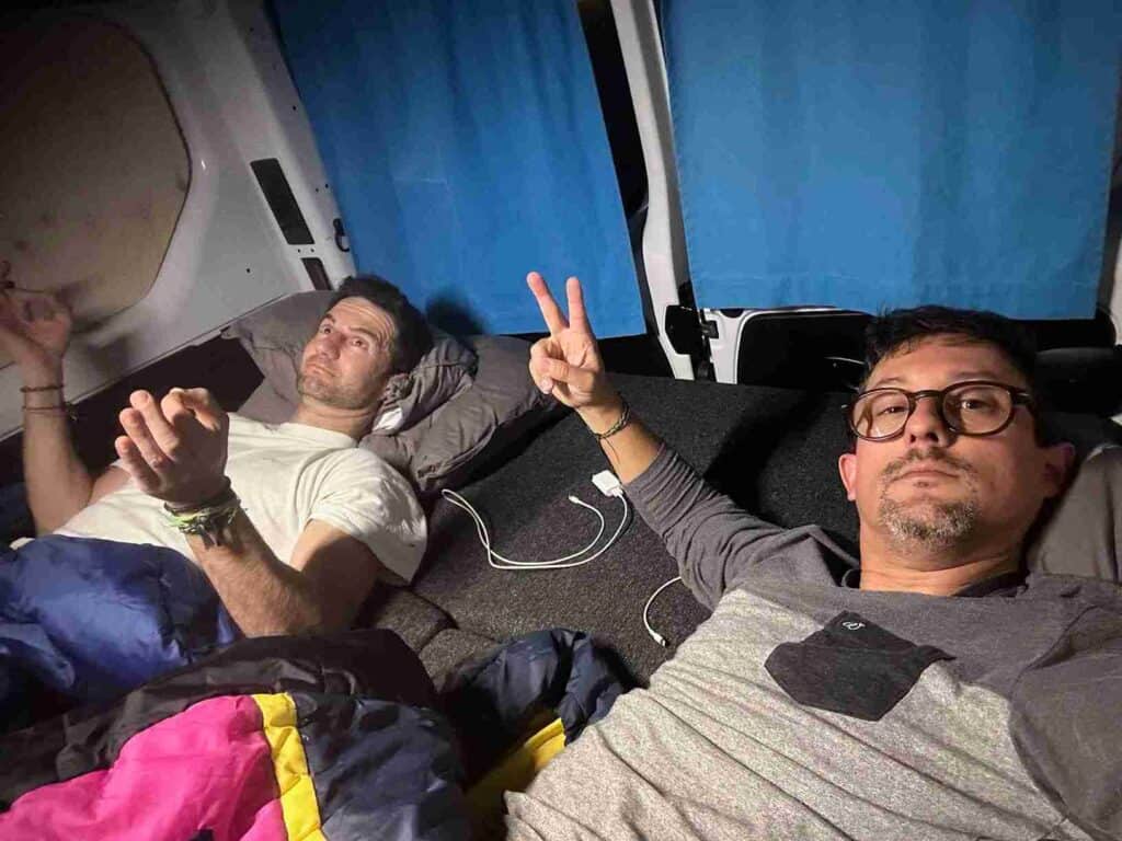 Two men sleeping inside the trafic 3 camper
