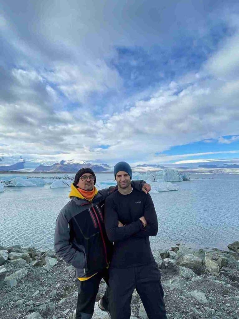 Two men posing by the glacier lagoon 