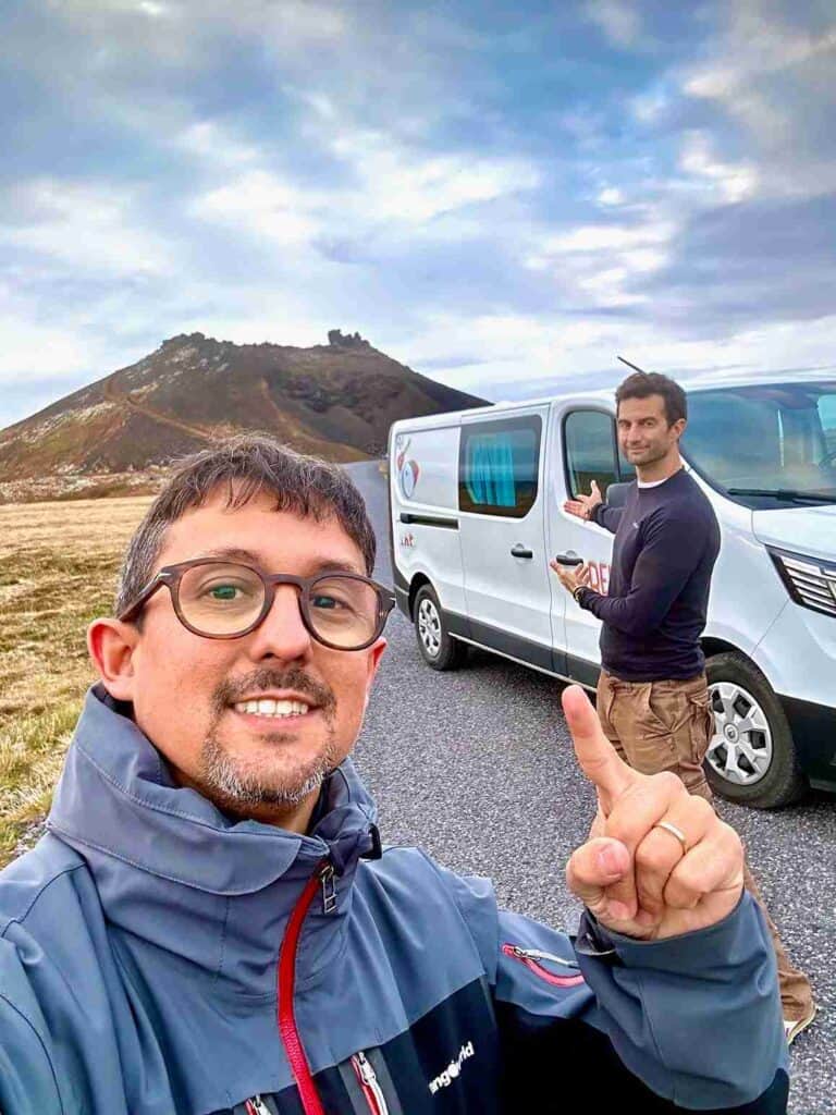 Two men standing by the trafic 3 camper