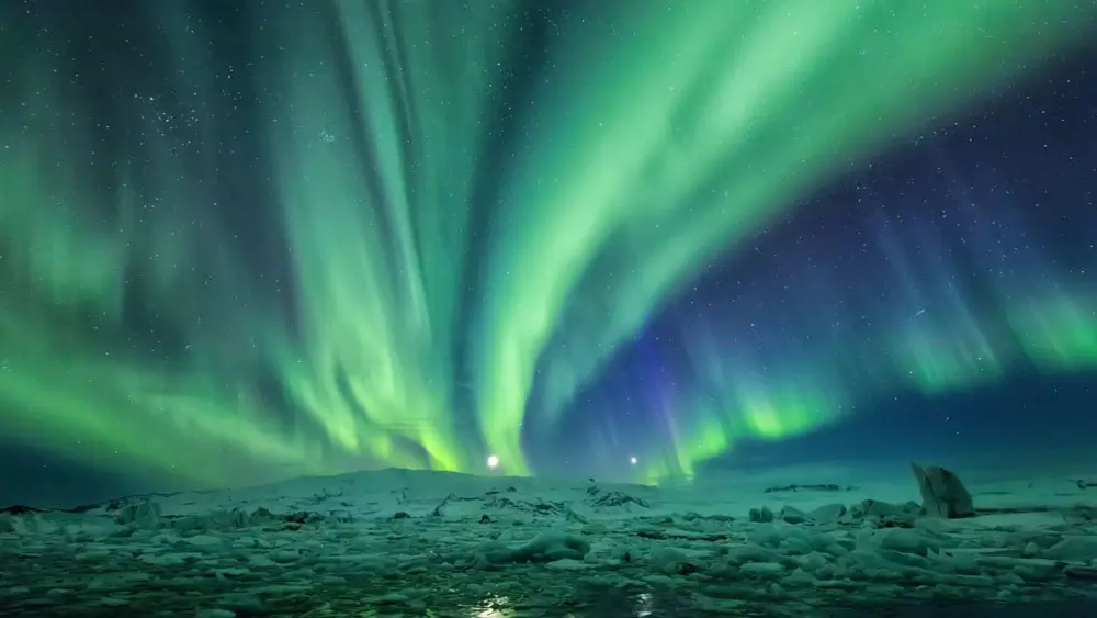 Northern Lights in Iceland over snow and ice.