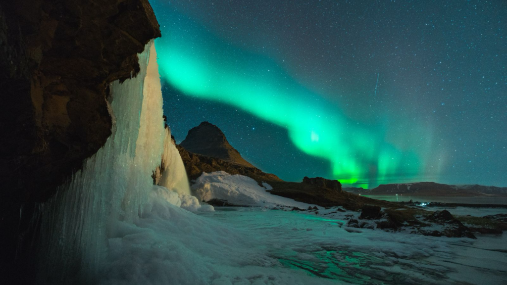 Kirkjufell under the Northern Lights in Iceland.