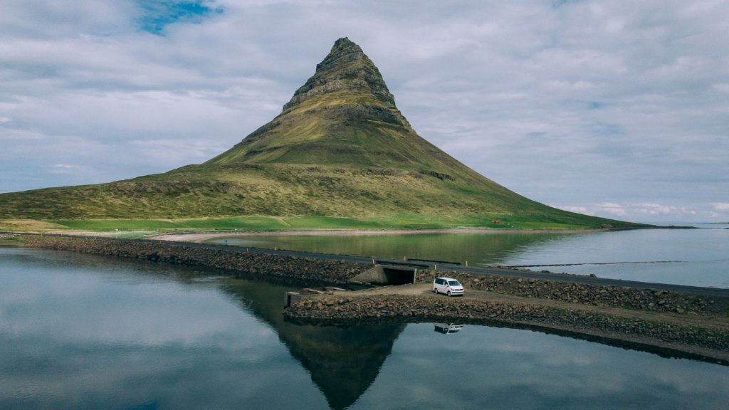Campervan in front of Kirkjufell Mountain in Iceland.