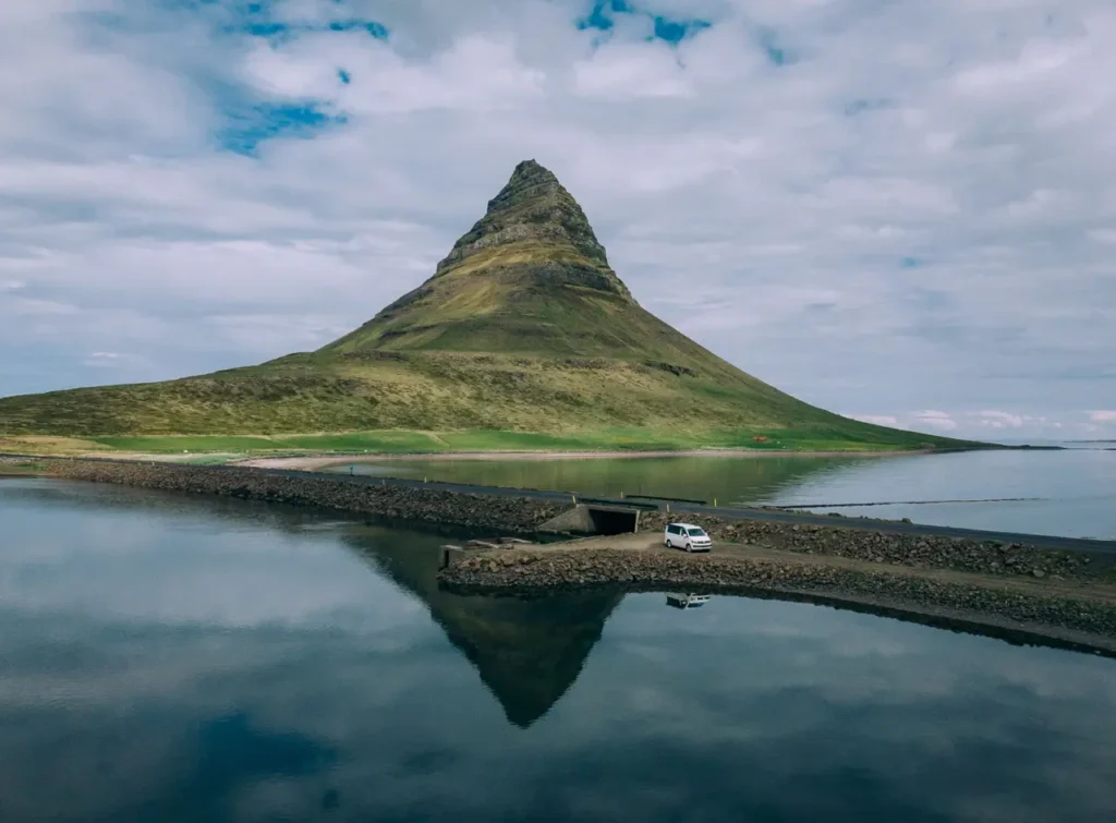 VW California automatic campervan parked on a gravel road in front of Kirkjufell Mountain