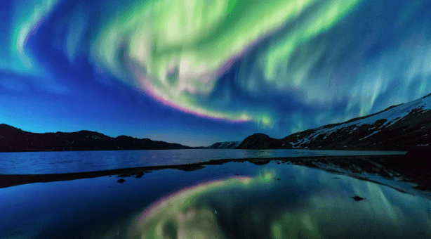 Northern Lights over a body of water in Iceland