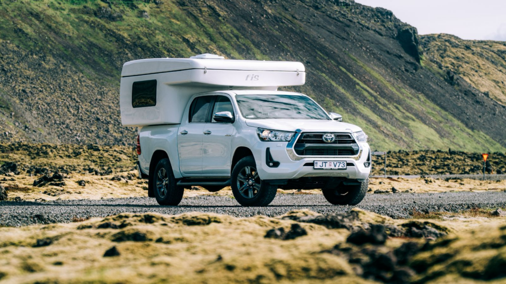 Toyota Hilux 4x4 on a remote road in Iceland with mountains in the background