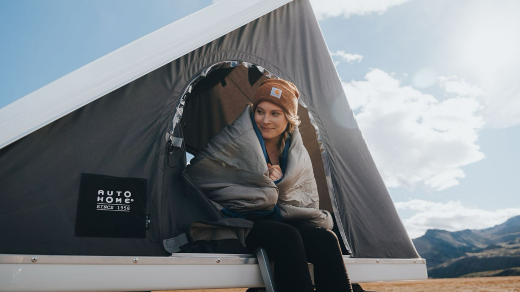 Solo traveler sitting in a pop-up tent in Iceland.