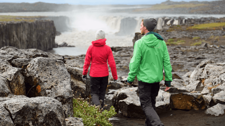 Couple in jackets hiking in Iceland.