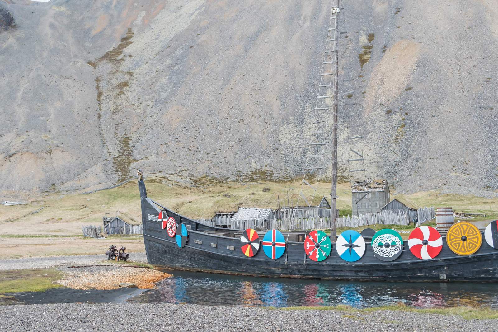 Viking longship with painted shields at the Viking Village film set beneath Vestrahorn