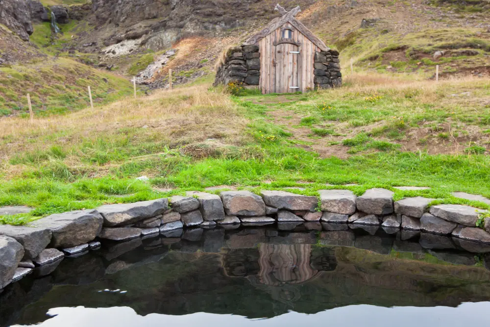 Hot spring in Iceland with small wooden hut for changing