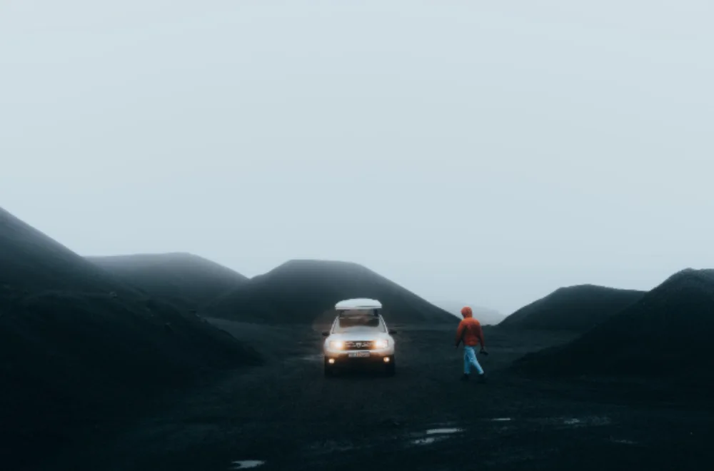 Dacia Duster 4x4 camper van parked on a gravel road in Iceland.
