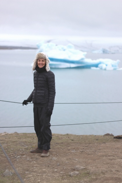 Woman stands by the glacier lagoon