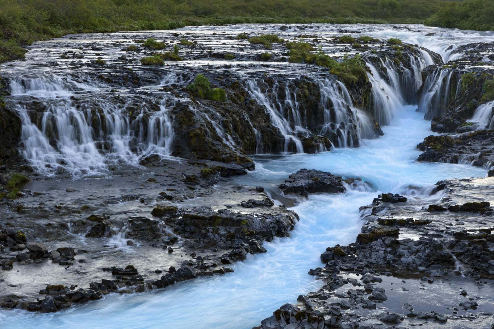 Close-up of the many small falls of Brúarfoss feeding turquoise water in Iceland