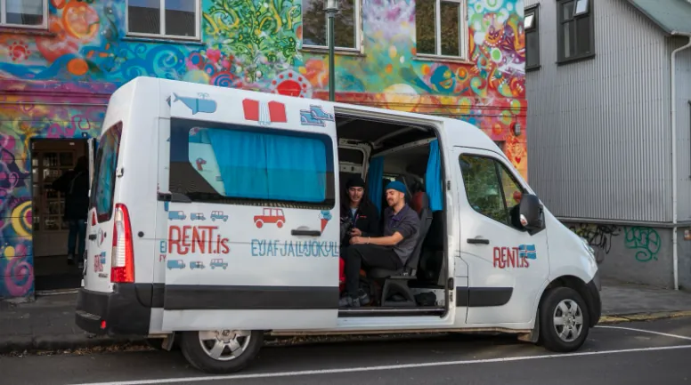 Renault Master 5 against a colorful building in Iceland.