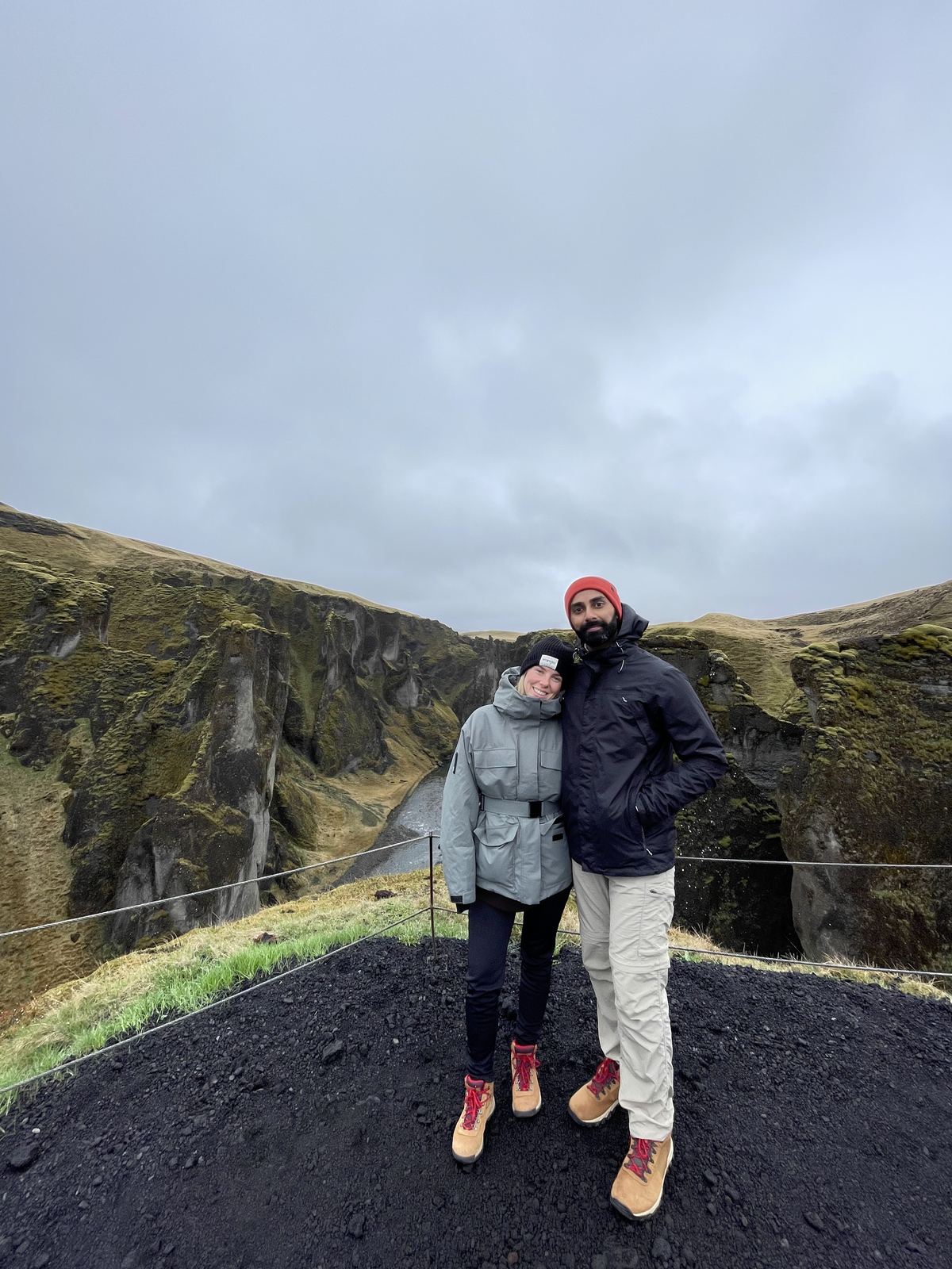 Couple at the Fjaðrárgljúfur canyon viewpoint near Kirkjubæjarklaustur