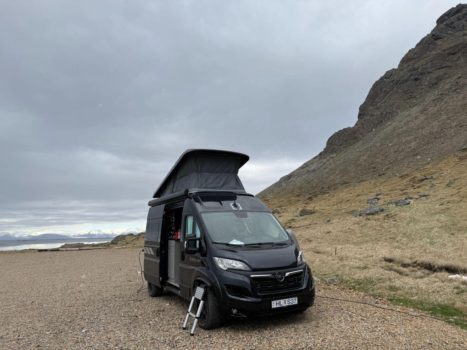 Crosscamp Flex 541 campervan with its pop-up roof open, parked by the coast in Iceland