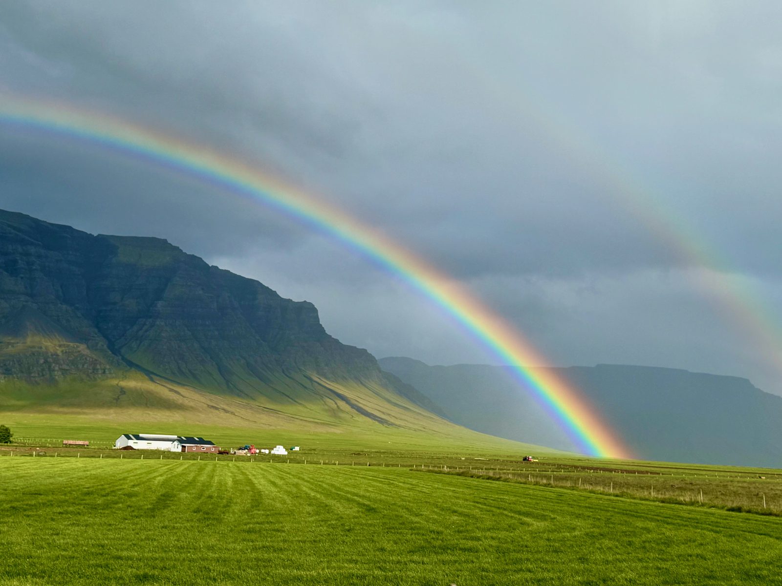 Double rainbow over green fields and mountains on the Snæfellsnes Peninsula in Iceland