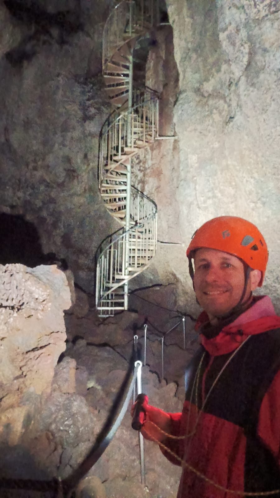 Visitor in a helmet inside Vatnshellir lava cave on the Snæfellsnes Peninsula