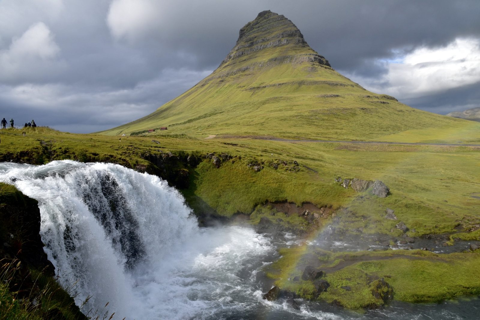 Kirkjufellsfoss waterfall with a rainbow in front of Kirkjufell mountain on Snæfellsnes