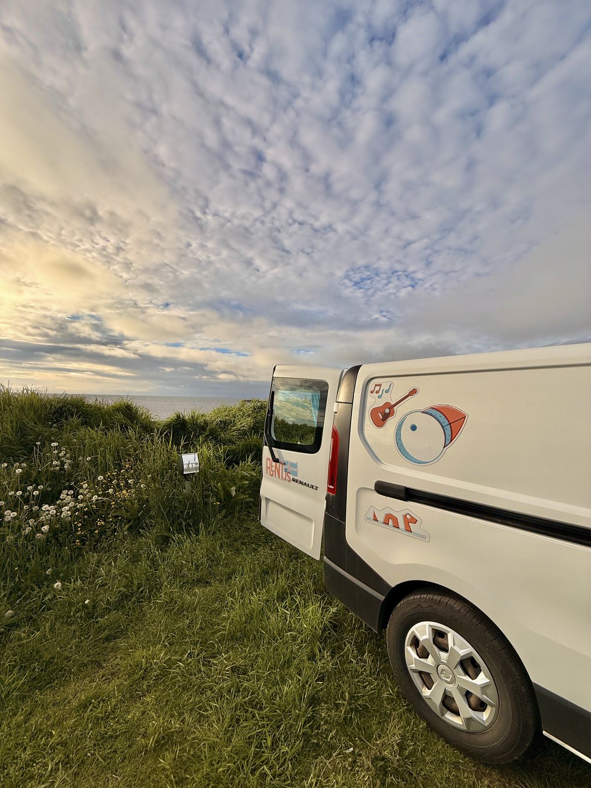 Renault camper van under a dramatic evening sky on the Icelandic coast