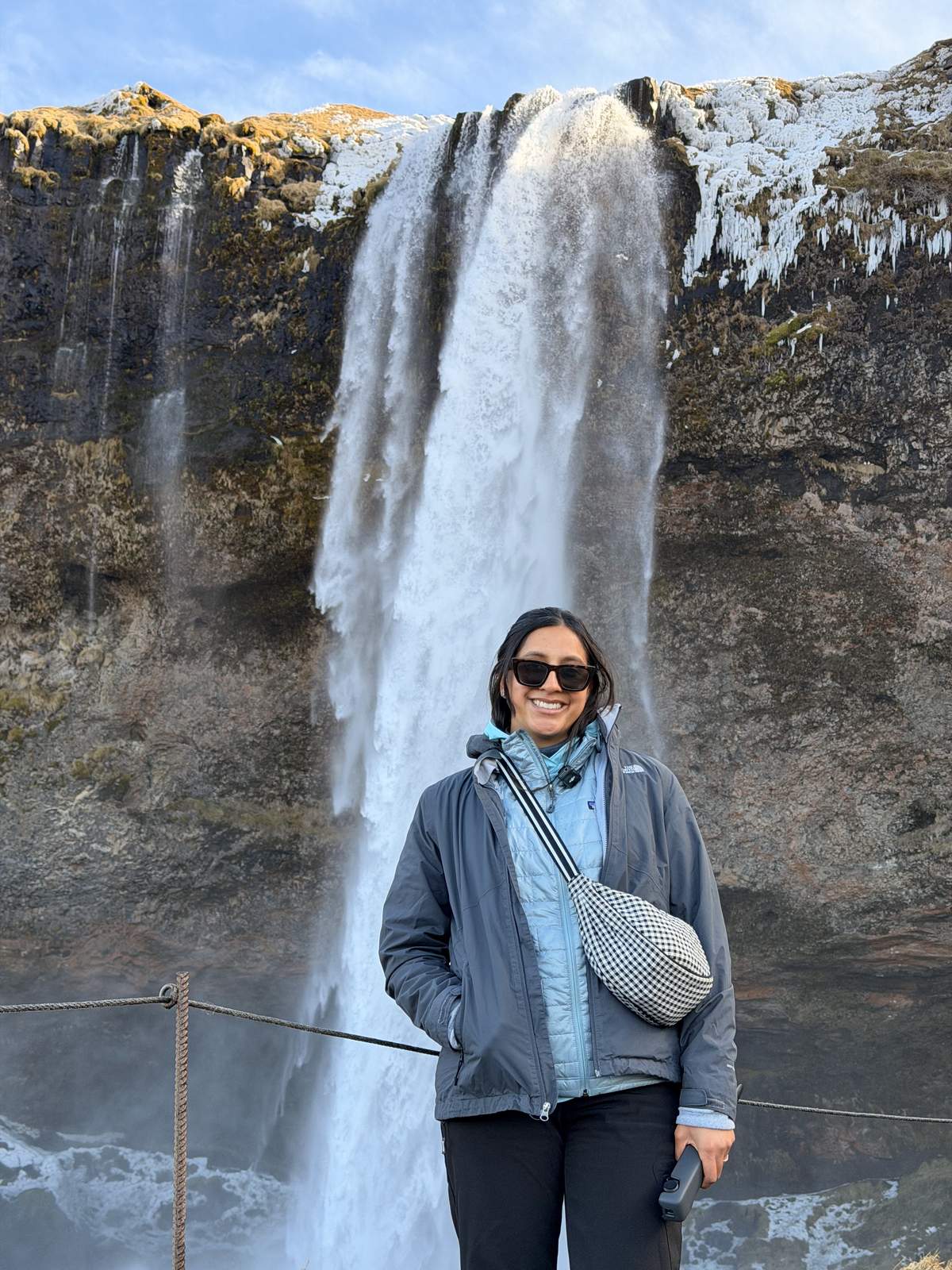 Standing in front of Seljalandsfoss waterfall in South Iceland
