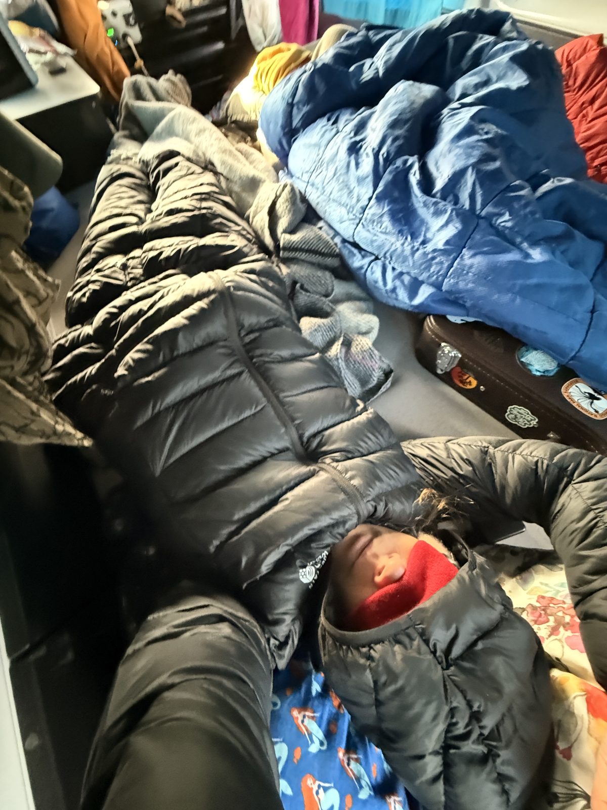 Sleeping bags and an eye mask inside the camper van to block out the midnight sun